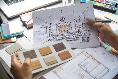 A designer looking through interior design plans
