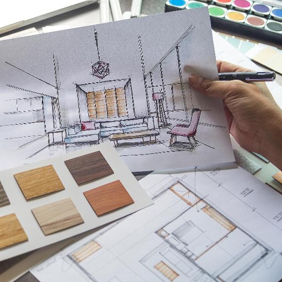 A designer looking over interior design plans